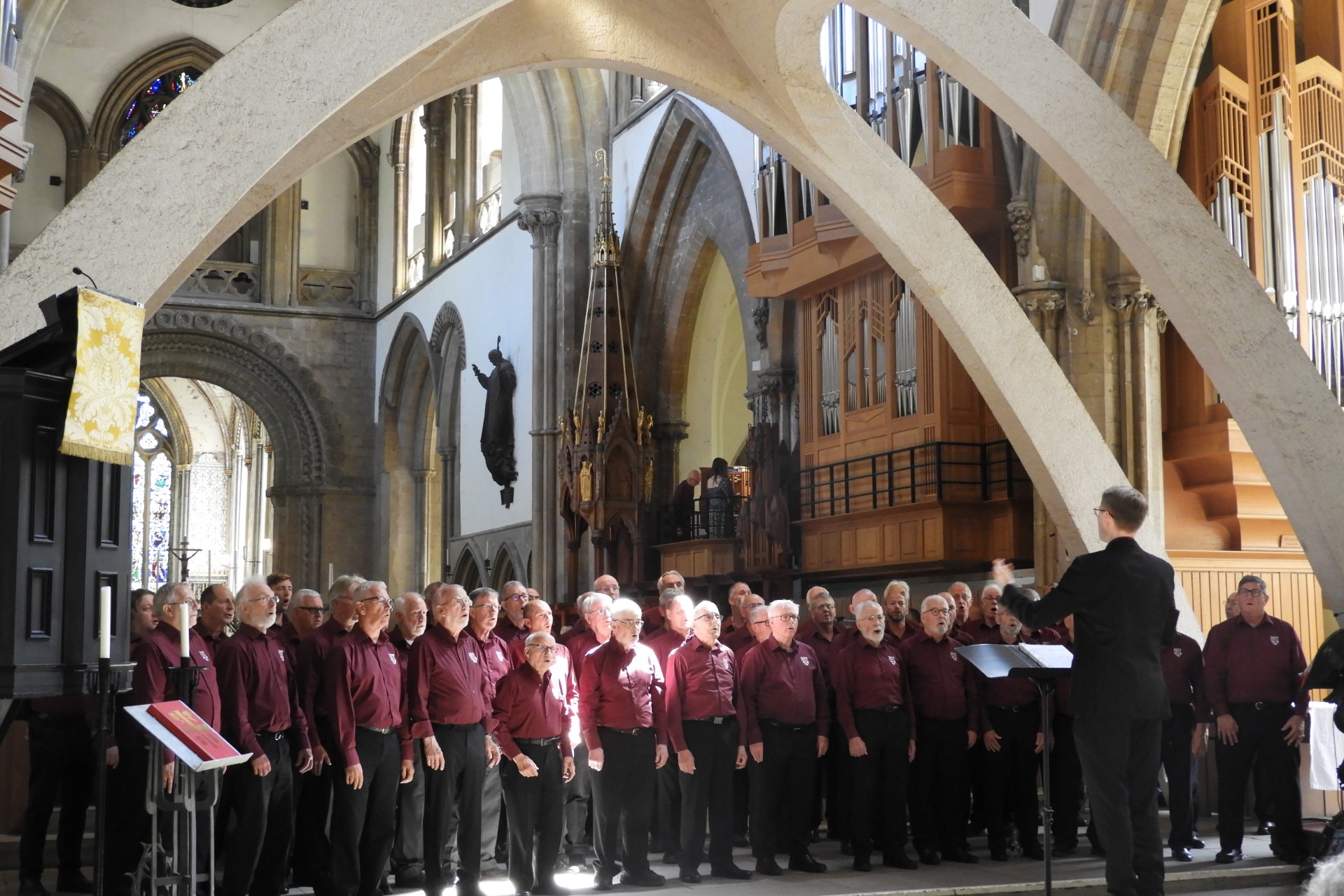 A male choir singing in a cathedral
